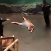 Bass Pro Shop nude swimmer depicting and image of the man laying on the floor being arrested by police.