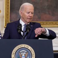 Joe Biden Dropping Out Of 2024 Presidential Election Joe Biden 2024 election drop out image example depicting the president staring at his watch during a speech.