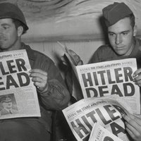 Hitler Dead Reaction Image depicting soldiers during WW2 reading about his death in newspapers.
