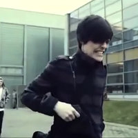 Emo Kid Clutching Gun Holding Back meme depicting Dominik Santorski clutching a gun and grimacing.