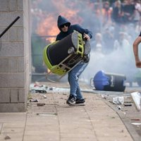 Protester throwing trash cam at police officer