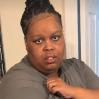 Shay showing the damage to her Ariana Grande shirt.