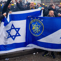 Israeli Maccabi Tel Aviv Fans Amsterdam Attack depicting a group of football fans in the Netherlands with flags celebrating.