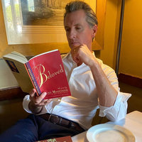 Image of Gavin Newsom reading a book.