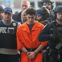 Luigi Mangione New York City Perp Walk Luigi Mangione Perp Walk Photograph in New York City, showing Mangione being escorted by police on all sides.