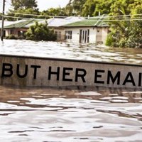 One of the popular "But Her Emails" memes showing a flooded street and a sign with the catchphrase. 