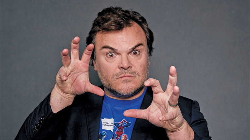 Jack Black in a blazer and a comic book t-shirt