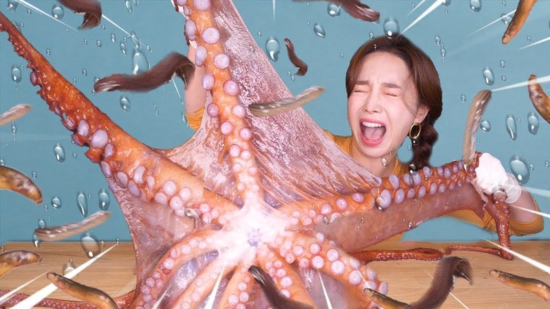 Woman shouting with her eyes closed while tearing apart a living octopus