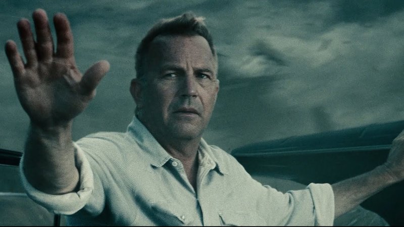 Jonathan Kent raising his hand to stop Superman from saving him