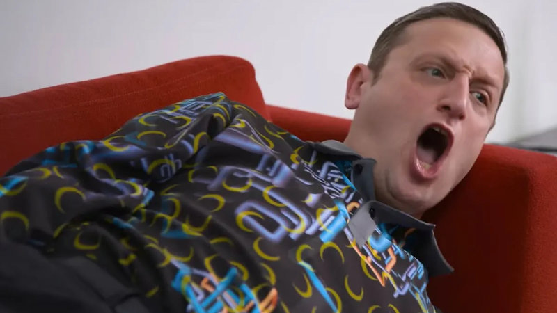 Tim Robinson wearing a shirt with a complicated pattern.