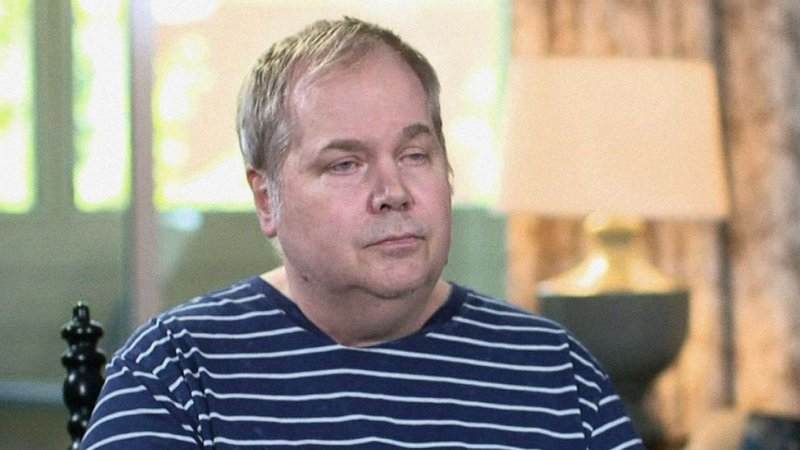 John Hinckley Jr., during a television interview wearing a striped shirt.