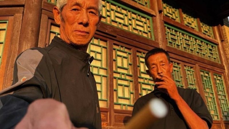 Chinese Man Offering A Cigarette