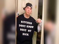 man in a backwards cap and t-shirt taking a mirror selfie