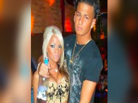 guy holding a bottle of vodka with his arm around a blonde woman