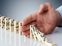 Hand Stopping Dominoes