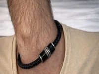 A photo of a man with his hand in his pocket. It also resembles someone with a skinny, hairy neck.