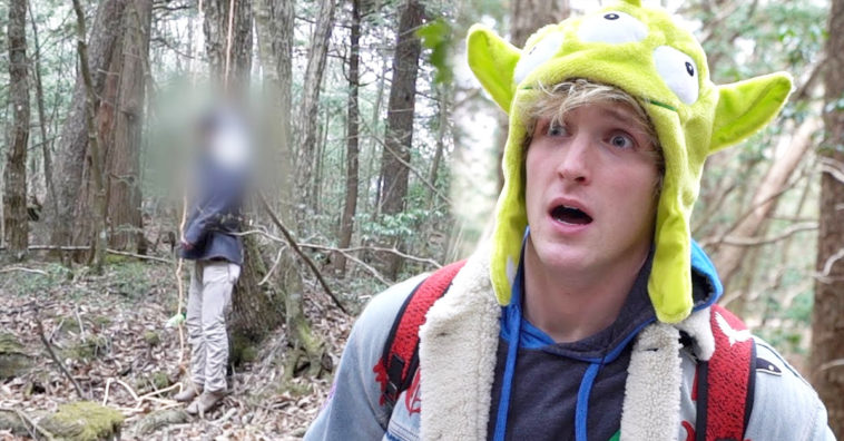 Logan Paul in a green alien hat looking shocked next to a blurred hanged person in a forest