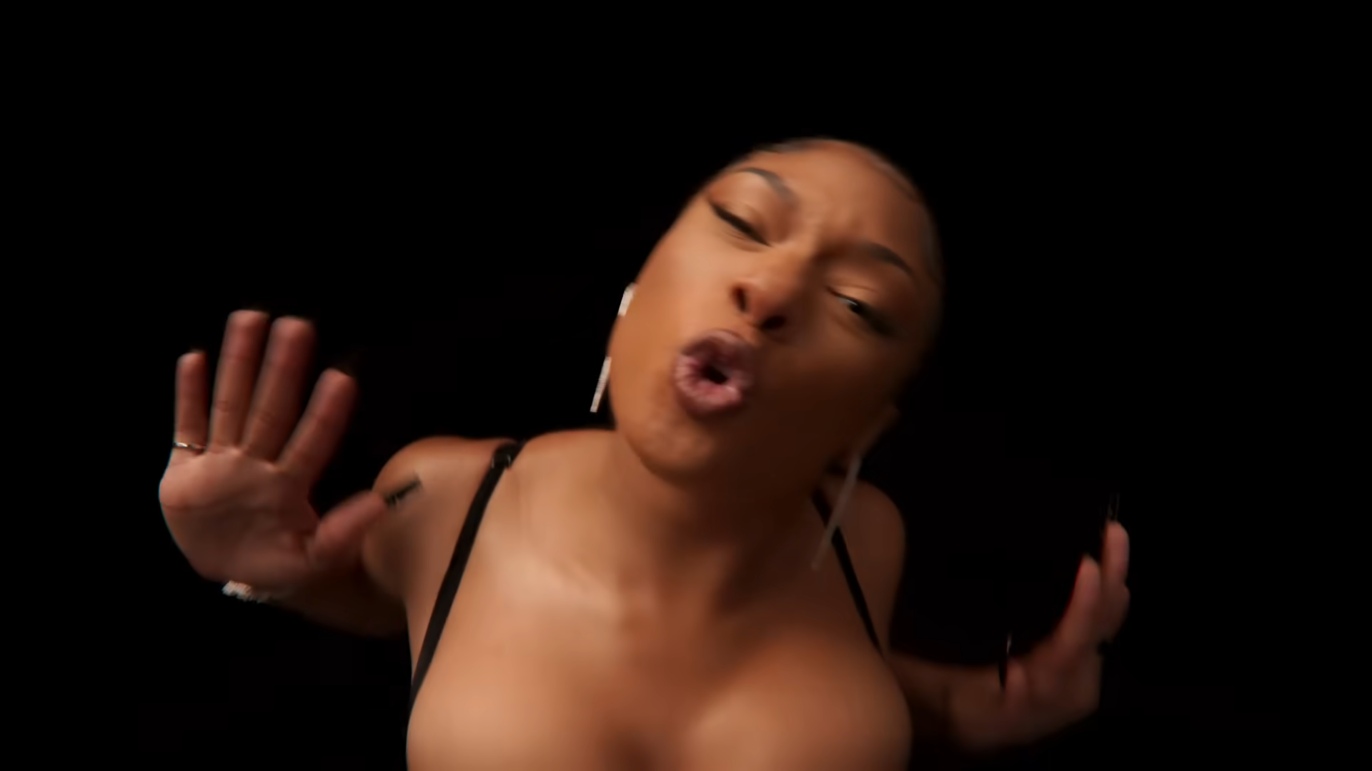 Megan Thee Stallion Pushing meme depicting the rapper pushing away the camera from her music video for her song Plan B.