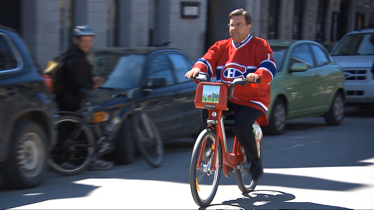 Denis Coderre riding a Bixi