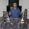 Man in blue shirt surrounded by CDs