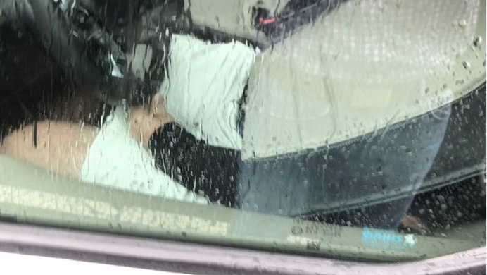 Man dressed as a car-seat drives van in the rain in Arlington, Virginia in the rain.