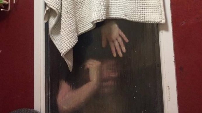woman trapped in window after trying to retrieve poop