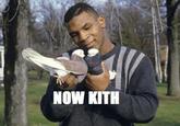 Mike Tyson holding two pigeons towards each other as if trying to make them kiss. The image is captioned "now kith."