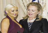 World Food Programme Ambassador singer Christina Aguilera (L) and US Secretary of State Hillary Clinton pose for a photo next to this year's McGovern Awards that were given to Aguilera and David Novak of Yum Brands, for their help fighting global hunger, on October 3, 2012, at the US Department of State in Washington, DC. (Paul J. Richards / AFP / Getty Images)