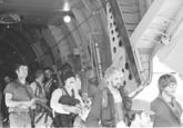 Operation Eagle Claw Mike Vining (on the right, with moustache) leaving the evac plane in Oman after the failure of Operation Eagle Claw.