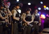 Officers from the St. Louis County Police, wearing riot gear, guard the perimeter of the scene of an officer-involved shooting on West Florissant Avenue in Ferguson, Mo.

Photo: Sid Hastings, epa