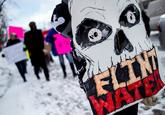 Protest poster Sign with much emotion put into the graphic of a skull at the protest for clean water for Flint Michigan