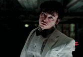 Gif of Joji George Miller in a white tuxedo