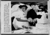 (JX2) JACKSON, Miss. Aug. 2--MARRIED IN MISSISSIPPI--Roger Mills and his new bride, the former Berta Linson, cut their wedding cake shortly after they were married in Jacks on, Miss., Sunday. The interracial marriage ended one of Mississippi's final racial barriers. (AP WIREPHOTO) (jrtl1630stf) 1970