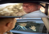furious 7 scene of vin diesel looking out the window of his car at paul walker but instead it's someone waving from the backseat of a limo