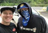 Shittymorph in a hoodie and a Subaru scarf over his mouth and nose posing for a selfie with another guy