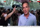 protester holds umbrella for journalist sky news LIVE 15:13 HONG KONG |skynews.com RTED IN THE VILLAGE OF BRADFIELD SOUTHEND IN BERKSHIRE ON THURSDAY NIGHT THE HOME OFFICE HAS ANNG