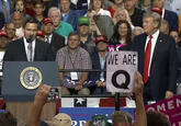 QAnon supporters at Trump rally MINGA ATAGA HESIDENT WC WE ARE SEAL Sake AR OMEN UNI TINE UNITED STATES