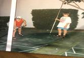 A photo from Maggie's childhood before she became a meme 90s photo two kids in sandals playing with sticks