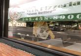 Mortal Kombat 4 arcade machine with Quan Chi on it seen from a window of a New York pizza place