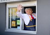 Cropped photograph of the United States presidential candidate and former president Donald Trump waving from a drive-thru window during his October 2024 photo op at a McDonald's restaurant in Pennsylvania