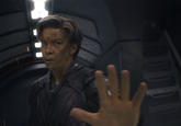 A still image of character Adam Warlock extending his hand in a "stop" gesture.