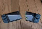 The original photoshop of a Nintendo Switch broken in half.
