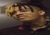 A photo of late "rapper":https://knowyourmeme.com/memes/cultures/rap-hip-hop "XXXTentacion":https://knowyourmeme.com/memes/people/xxxtentacion in the "What's That? What's a Father?" meme, seen wearing a black polo shirt and metal choker necklaces.