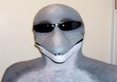 A photo of the "Dolphin Man" wearing sunglasses, sourced from the website of the latex prosthetic manufacturer NorthFur FX. The image inspired the Dolphin Man "creepypasta":https://knowyourmeme.com/memes/creepypasta.