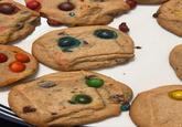 A photo of a cookie that looks like a sad face. This is the original image by X user AphexQuinn.
