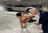 A photoshop of Rubi Rose bending over in a parking garage in front of her Cybertruck. Biden has been added, sniffing her.