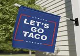 A flag on a house reading "Let's go TACO." The flag references Trump.
