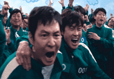 A "GIF":https://knowyourmeme.com/memes/cultures/gif from season 2 of the South Korean "Netflix":https://knowyourmeme.com/memes/sites/netflix show "_Squid Game_":https://knowyourmeme.com/memes/subcultures/squid-game in which the protagonist, "Seong Gi-hun":https://knowyourmeme.com/memes/seong-gi-huns-id-photo (Player 456), is cheering and celebrating with a group of players during the Six-Legged Pentathlon game in episode 5, titled "One More Game."