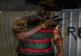 A photo of streamer "Low Tier God":https://knowyourmeme.com/memes/people/low-tier-god, also known as LTG or Dale Wilson, wearing an outfit inspired by the character "Freddy Krueger":https://knowyourmeme.com/memes/smoking-freddy-krueger from the _A Nightmare on Elm Street_ horror film franchise.