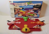 MB. Miton Bradley Ages 4 and Up Hungry Hungry Hippos The action's fast and frantic as your hippo reaches out and "swallows" that last marble! GAME 2 to 4 Players HARRY HIPPO